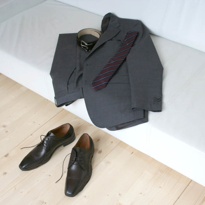 Photo men`s business shoes-Sophisticated design-dark brown mocha tone-2 shoes with a gray suit on a couch